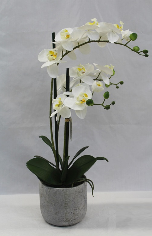 Artificial orchid in white vase height 60 cm